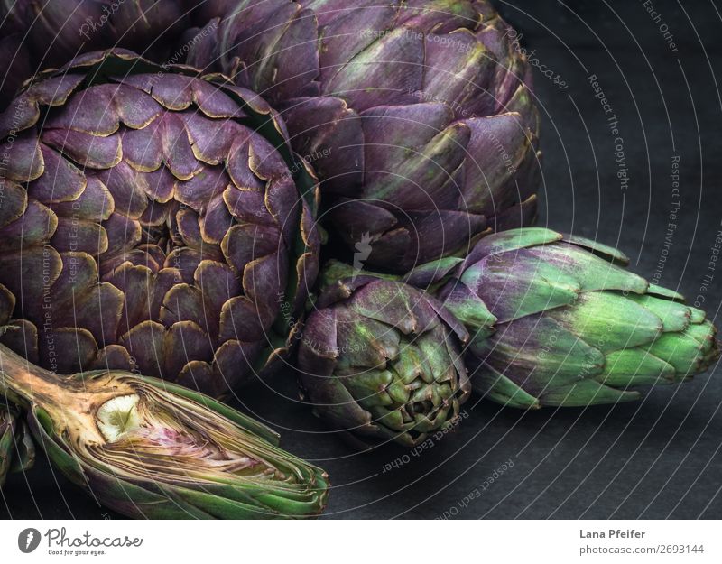 Artistic display of assorted artichokes Vegetarian diet Wallpaper Kitchen Dark Fresh Natural Artichoke background detailed in section whole Purple food healthy