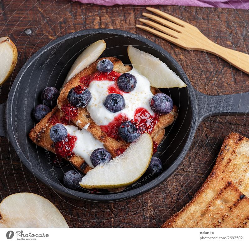 French toast with berries, syrup and sour cream Fruit Bread Dessert Nutrition Breakfast Lunch Pan Fork Table Wood Fresh Delicious Red White background Berries