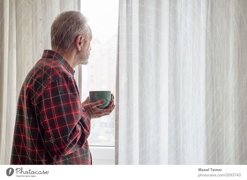 Mature man drinking his coffee and looking out of the window Drinking Coffee Tea Human being Man Adults Town Observe Think Stand Wait Green Red White Caucasian