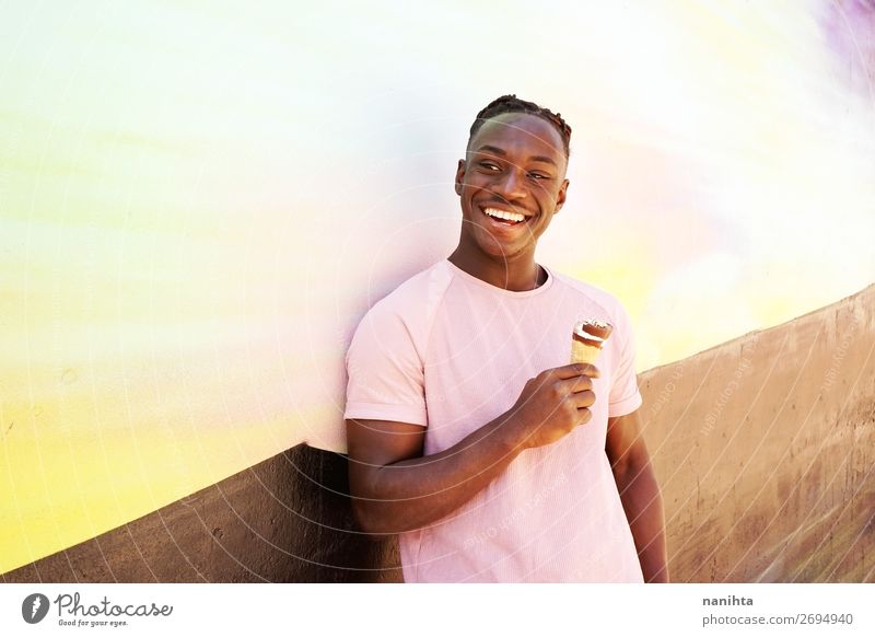 Young handsome black man holds an ice cream Food Ice cream Eating Lifestyle Style Happy Wellness Summer Sunbathing Human being Masculine Young man