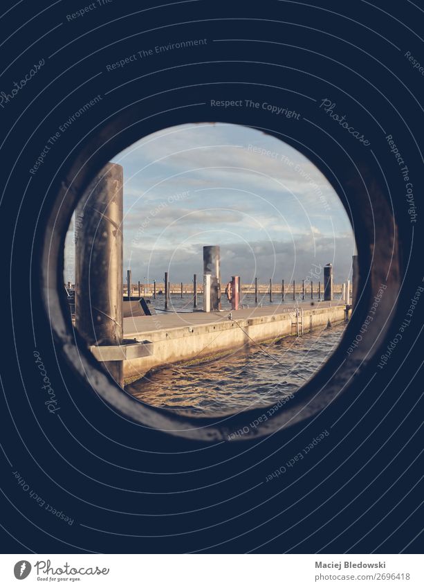 Harbor seen through an old ship porthole. Vacation & Travel Tourism Freedom Cruise Summer vacation Ocean Island Horizon Harbour Navigation Boating trip