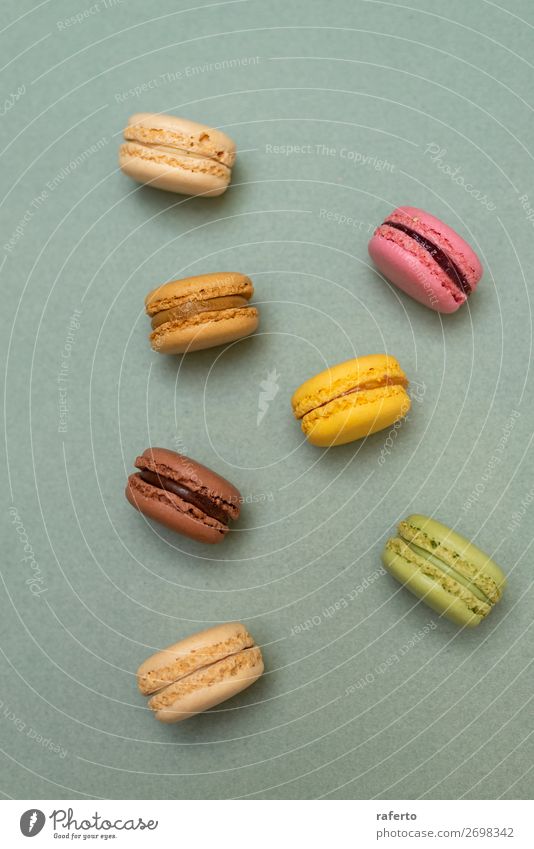 Cake macaroons or macaroons on green background from above Dessert Gastronomy Fresh Bright Delicious Soft Yellow Green Colour 999 OLDER Beaded Orange Purple