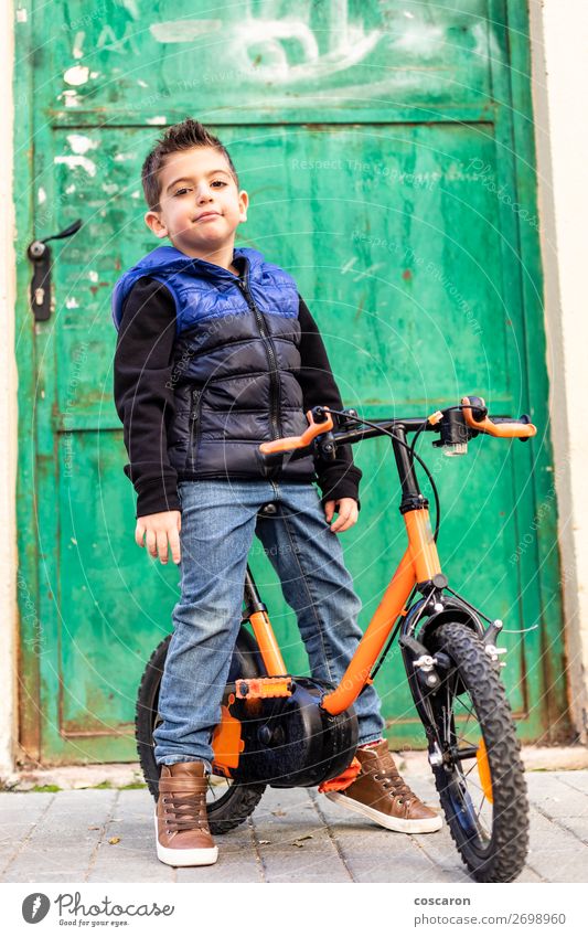 Little boy on his bicycle on the hood Lifestyle Joy Playing Sportsperson Cycling Bicycle Child School Schoolchild Human being Baby Toddler Boy (child) Man