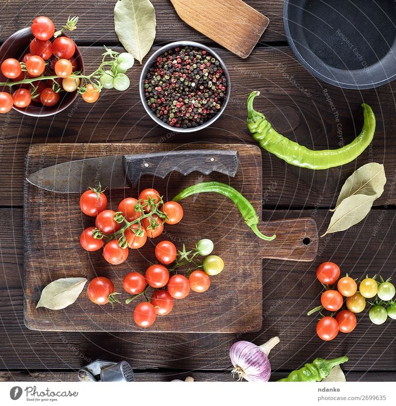ripe red cherry tomatoes on a brown wooden table Vegetable Herbs and spices Vegetarian diet Pot Pan Knives Summer Kitchen Wood Fresh Small Natural Above Green