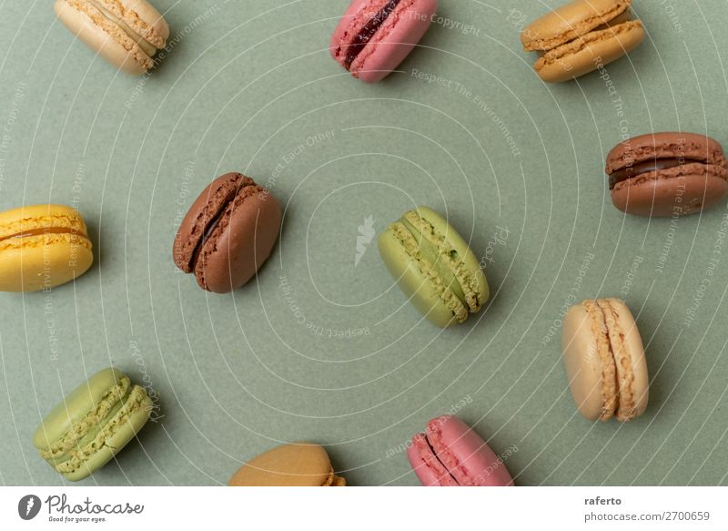 Cake macaroons or macaroons on green background from above Dessert Gastronomy Fresh Bright Delicious Soft Yellow Green Colour 999 OLDER Beaded Orange Purple