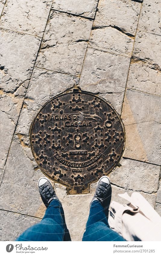 Woman stands on manhole cover in Cascais Feminine 1 Human being Vacation & Travel Gully Portugal Symbols and metaphors Sneakers Jeans Tourism Vacation photo Sun