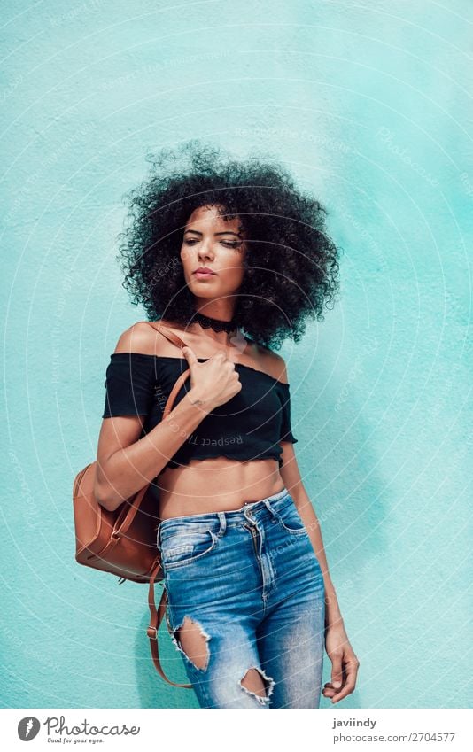 Young mixed woman with afro hair standing on the street - a Royalty Free  Stock Photo from Photocase