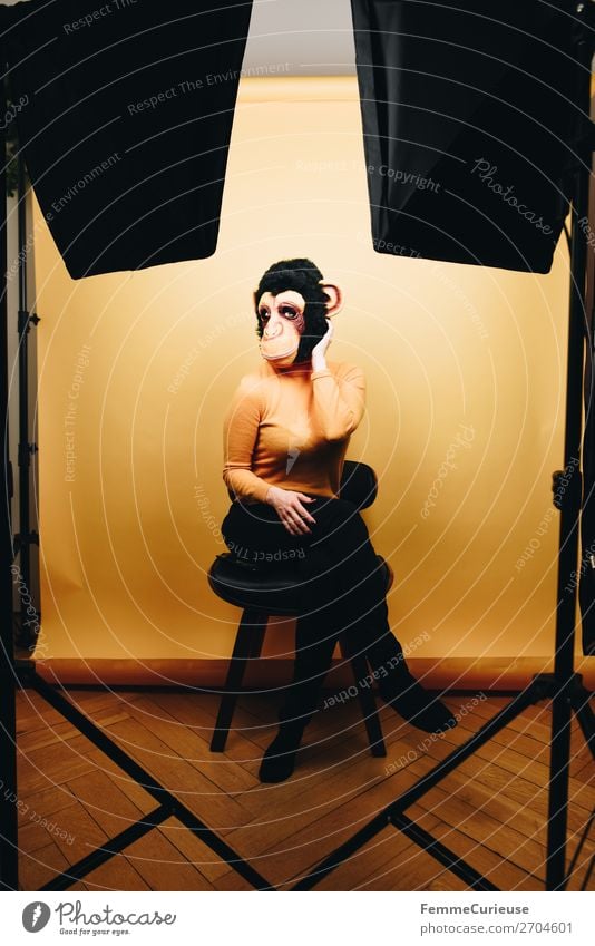 Woman with monkey mask posing in photo studio Feminine Adults 1 Human being 18 - 30 years Youth (Young adults) 30 - 45 years Joy Mask Monkeys Chimpanzee