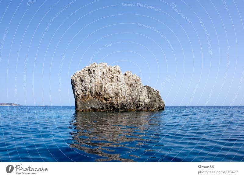 Rock in the surf Environment Nature Landscape Water Sky Cloudless sky Horizon Summer Beautiful weather Waves Coast Reef Ocean Stone Old Power Safety Protection