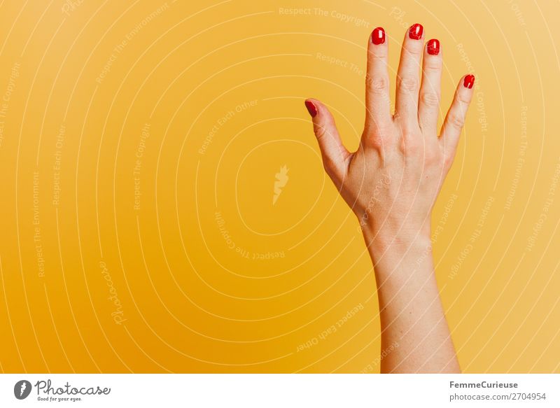 Forearm and hand with spread fingers against a yellow background Feminine Woman Adults 1 Human being Nail polish Red Yellow Fingers Hand Joint hand surface