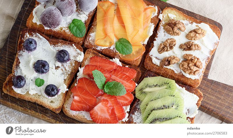 French toasts with soft cheese Cheese Fruit Bread Dessert Breakfast Lunch Wood Fresh Above Soft Green Red White appetizer background Berries Blueberry board