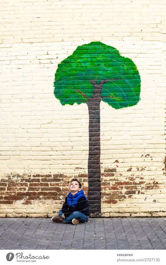 Little kid seated under a tree painted on a wall Joy Happy Beautiful Life Playing Adventure Summer Winter Garden House building Climbing Mountaineering Child