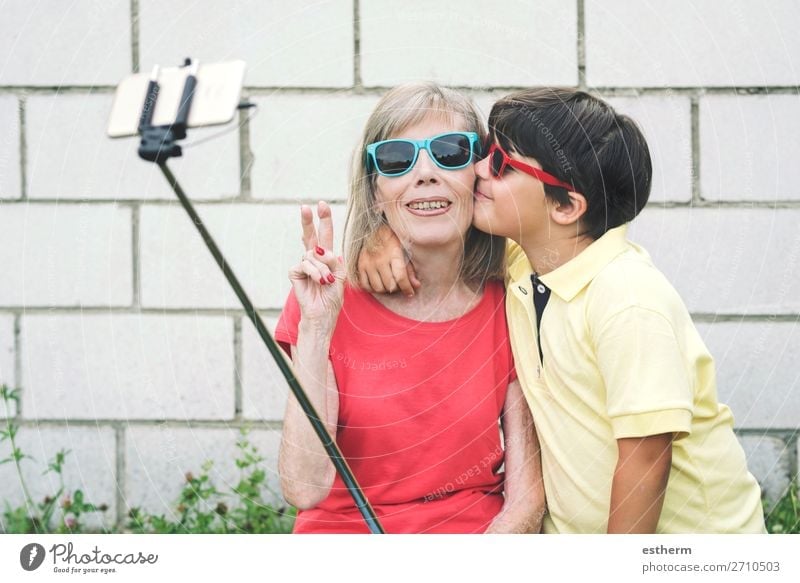 funny Grandmother and Grandson with sunglasses taking selfie using smartphone Lifestyle Joy Retirement Cellphone Camera Human being Masculine Feminine