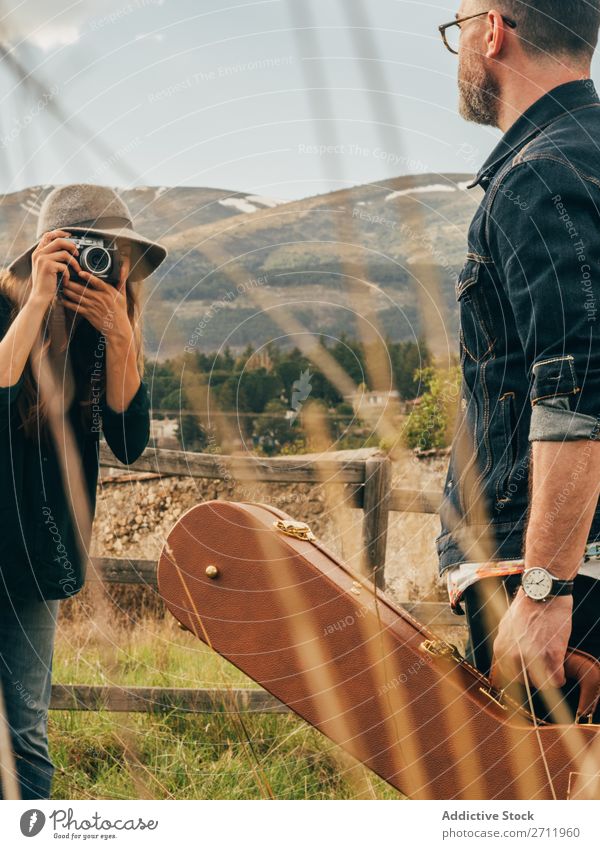Woman taking shot of man with guitar Man Guitar Nature Musician Photographer To fall Rural Fence Lifestyle Human being Summer Easygoing Acoustic handsome Guy