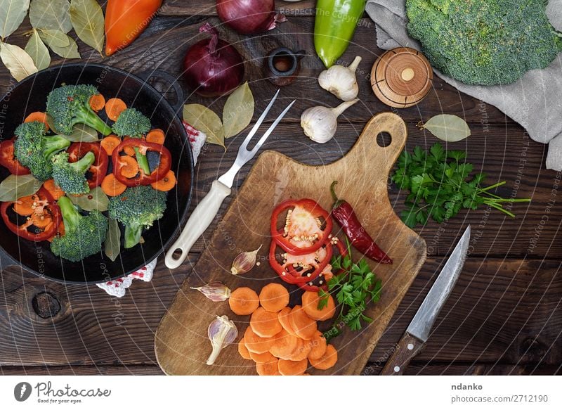 fresh pieces of carrots, broccoli Vegetable Nutrition Eating Vegetarian diet Diet Pan Knives Fork Table Kitchen Nature Plant Wood Fresh Natural Brown Green Red