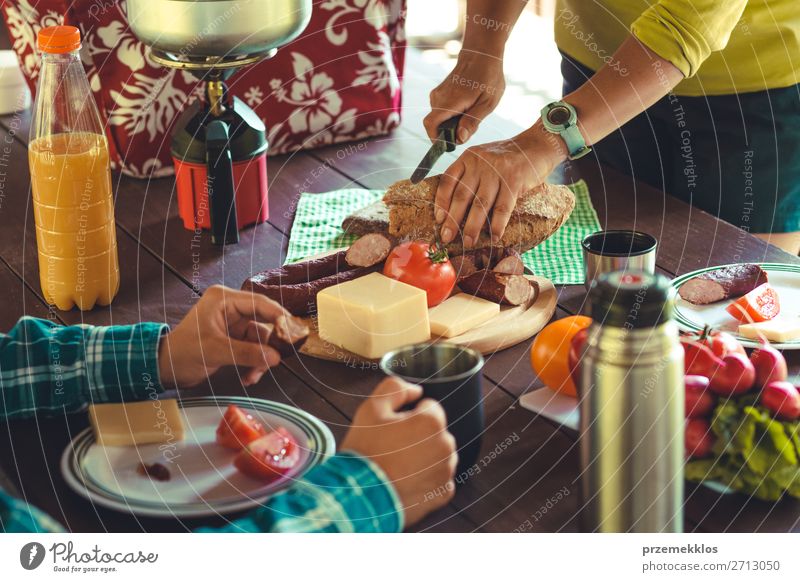 Preparing and eating a breakfast outdoor Sausage Cheese Vegetable Bread Juice Bottle Lifestyle Vacation & Travel Camping Summer Summer vacation Table Woman