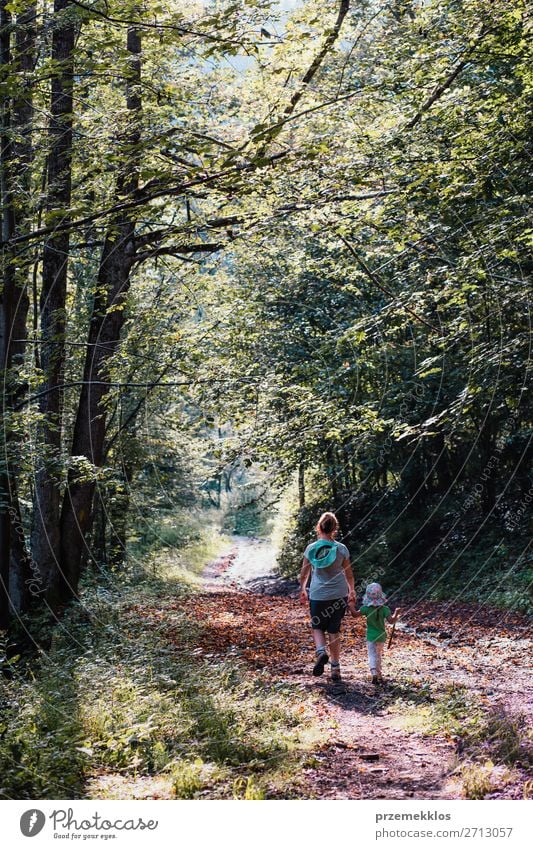 Mother with daughter walking through the forest Lifestyle Joy Happy Relaxation Leisure and hobbies Vacation & Travel Tourism Trip Summer Summer vacation Hiking