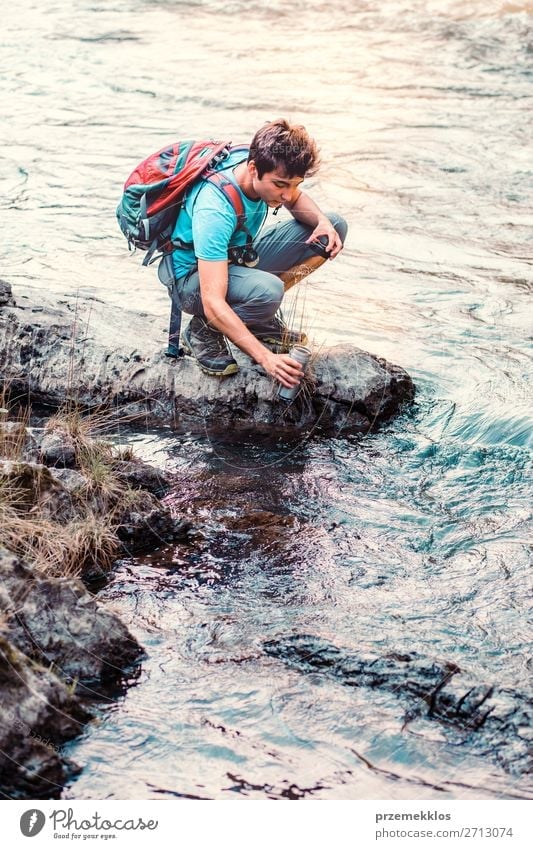 Young wanderer takes pure water from a river Body Life Hiking Human being Boy (child) Young man Youth (Young adults) Man Adults 1 18 - 30 years Environment
