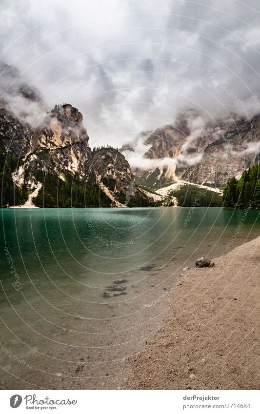 Braies Lake with clouds in the Dolomites I Tourism Structures and shapes Copy Space bottom Vacation & Travel Light Copy Space right Shadow Contrast