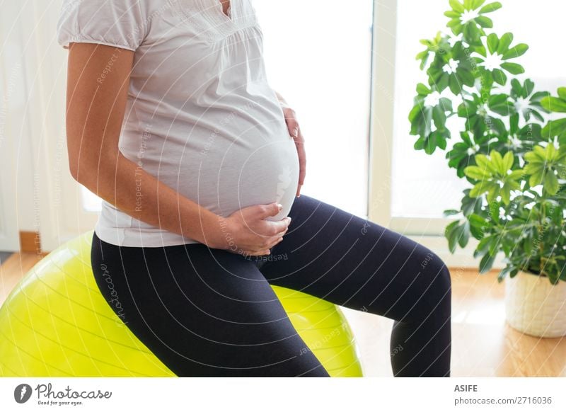 Pregnant woman exercising at home Happy Body Sports Baby Woman Adults Parents Mother Hand Touch Fitness Sit Green Future pregnancy Practice Home ball Pilates