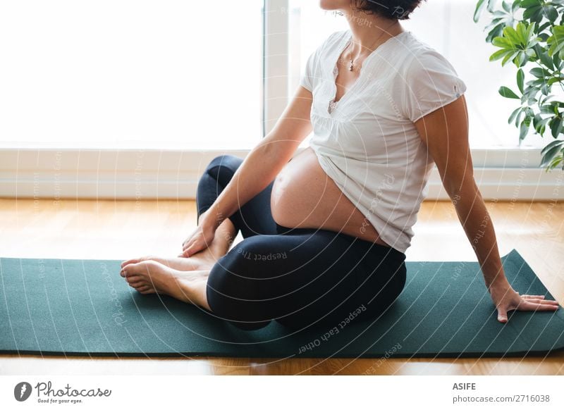Pregnant woman exercising on a mat at home Happy Body Relaxation Sports Yoga Baby Woman Adults Parents Mother Fitness Green Future pregnancy Practice Home Mat