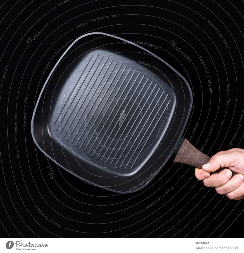 hand is holding a black empty square grill pan Pan Kitchen Restaurant Profession Man Adults Hand Black Cast iron Caucasian chef cook cooking Domestic equipment