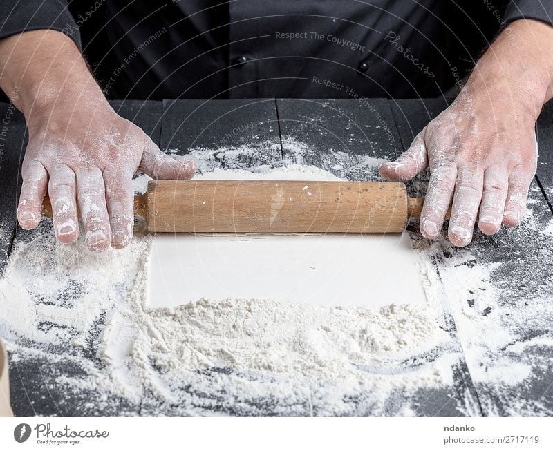 wooden rolling pin in male hands Dough Baked goods Bread Table Kitchen Profession Cook Human being Man Adults Hand Wood Make Fresh Black White Baker Bakery