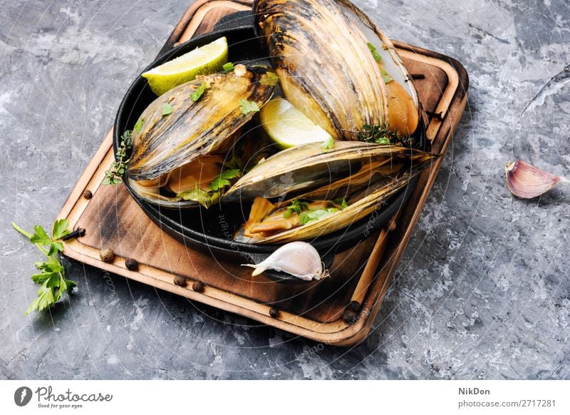 Delicious seafood mussels dish gourmet cooked shellfish parsley fresh cuisine boiled lemon mollusk eating pan steamed frying pan french herb table rustic tasty
