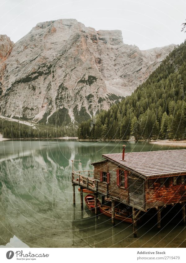 Wooden house with boats among mountains Dock Mountain Lake Jetty Serene House (Residential Structure) Forest Watercraft Tree Landscape Reflection coniferous