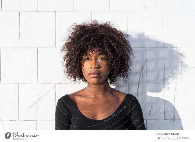 Ethnic woman at white wall Woman pretty Beautiful Youth (Young adults) Portrait photograph Human being Attractive Curly Black Face Nationalities and ethnicity