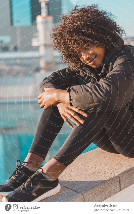 Stylish woman sitting on fence Woman Ethnic pretty Beautiful Youth (Young adults) City Park Sit Fence Style Easygoing Cool (slang) Portrait photograph