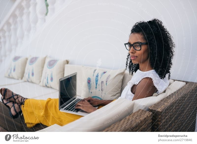 Woman working from home at the yard on her computer Business Ethnic Computer Communication Curly hair Work and employment Technology Profile Study Copy Space