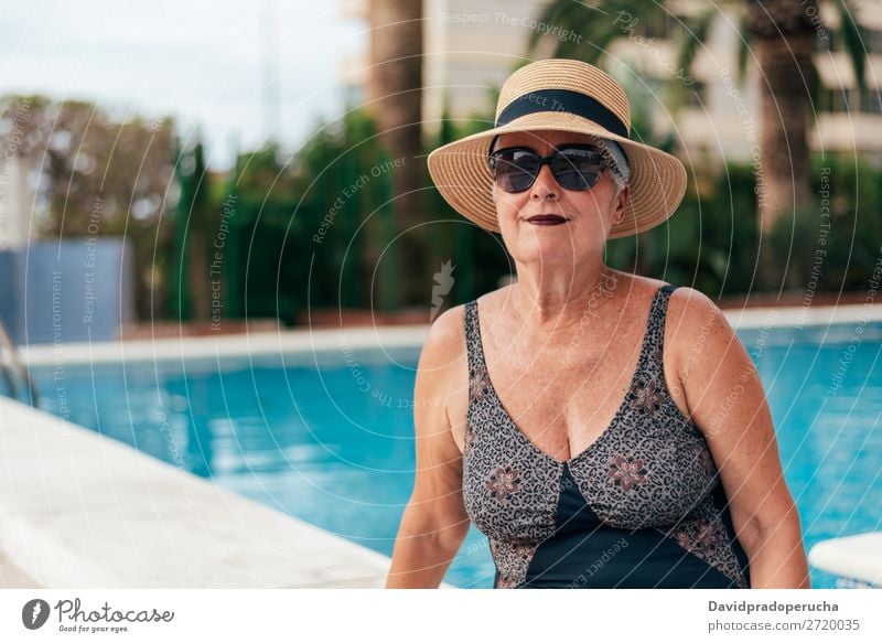 Senior old woman grey hair sitting by the swimming pool Woman Vacation & Travel Old Swimming pool Senior citizen Leisure and hobbies Wellness Caucasian Natural