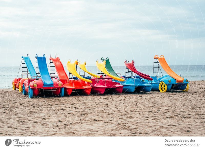 colorful Pedalos on the beach sand Beach Summer Watercraft Multicoloured Paddle Vacation & Travel Catamaran Red Background picture White Yellow Exterior shot