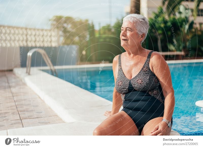 Senior old woman grey hair sitting by the swimming pool Woman Vacation & Travel Old Swimming pool Senior citizen Leisure and hobbies Wellness Caucasian Natural