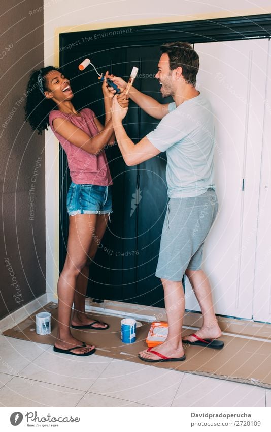 Interracial couple painting a wardrobe Painting (action, artwork) Relationship diy paint roller Paintbrush Design Cheerful Couple 2 Happy Love Home interracial