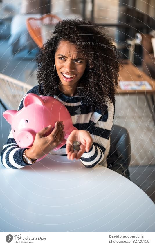 Thoughtful confused black woman with piggy bank Woman Money box Considerate debt Crisis Expression Irritation mistake Sadness Budget worried disappointed