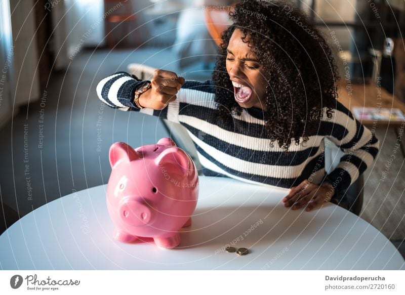 Black unhappy woman angry at piggy bank Woman Money box savings Crisis Sadness Anger Stress Emotions annoyed Scream trouble Expression frustrated Problem