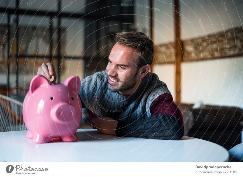 Happy young man with saving piggy bank Man Money box savings Success Business cash Caucasian Coin Euro Beautiful Cheerful investment wealth Budget