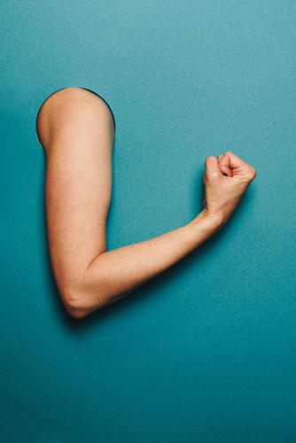 Arm of a woman with a sporty gesture Feminine Woman Adults 1 Human being Stationery Paper Sports Musculature Nerviness Tension Turquoise Fist Concentrate Circle