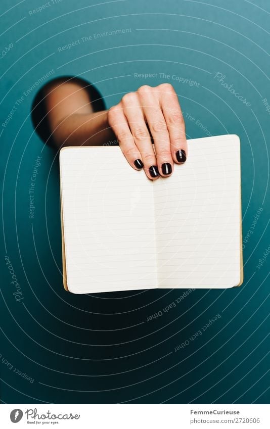 Hand of a woman holding a notebook in the camera Feminine 1 Human being Stationery Paper Creativity Notebook Lined Turquoise Nail polish Empty Write Design