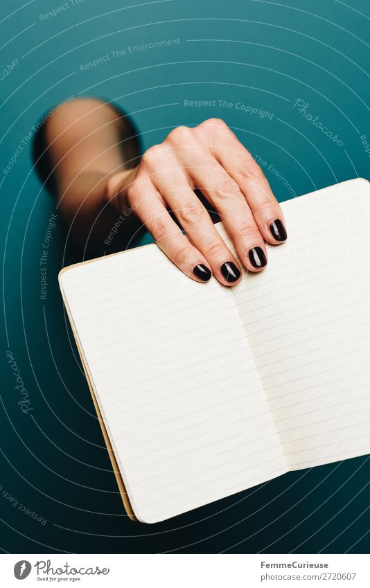 A woman's hand holding an empty notebook Feminine 1 Human being Stationery Paper Piece of paper Communicate Notebook Write Empty Nail polish Black Turquoise