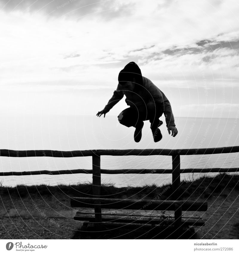 Hiddensee | Tribute to Kalle Jump Playing Youth (Young adults) 1 Human being Sky Clouds Coast Dark Athletic Power Park bench Ocean Black & white photo