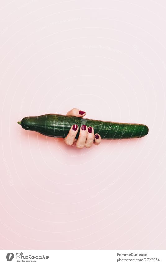 Hand of a woman with cucumber in front of pink background Food Nutrition Breakfast Lunch Picnic Organic produce Vegetarian diet Diet Feminine 1 Human being
