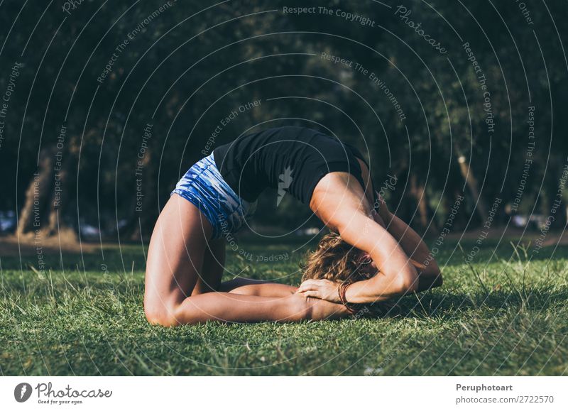 Woman stretching in Kapotasana yoga pose under the morning sun Lifestyle Summer Sports Yoga Feminine Adults River bank Pigeon Fitness Athletic Thin Concentrate