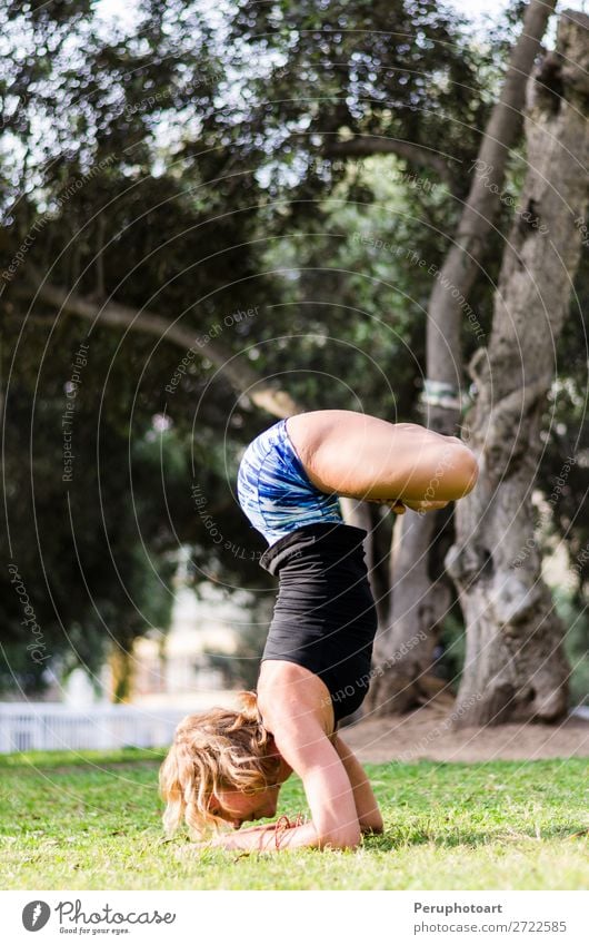 Young girl standing on her head doing yoga in the park Lifestyle Beautiful Body Relaxation Meditation Summer Sports Yoga Human being Woman Adults Nature Autumn