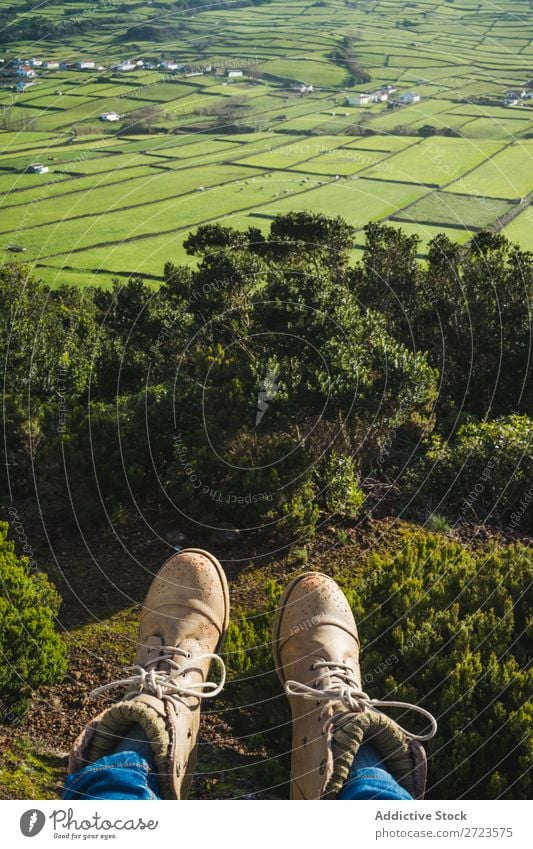 Person sitting on hill at fence Field Green Vantage point Nature Meadow Legs Footwear Grass Landscape Rural Summer Plant Azores Spring Lawn Landing Environment