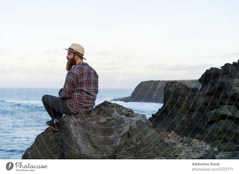 Tourist relaxing on stone at seaside Nature Man bearded Ocean Rock Stone Coast Beach Sit Resting Vacation & Travel Adventure Landscape Azores Hiking