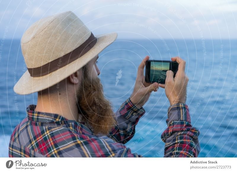 Tourist man taking a photo Nature Man bearded Cheerful Indicate seaside Ocean Vacation & Travel Azores Adventure Landscape Hiking Exterior shot Vantage point