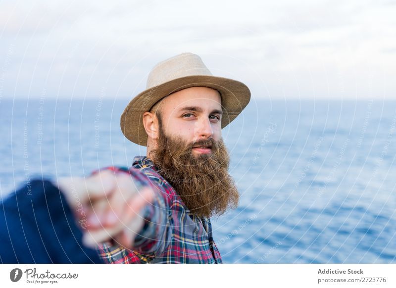 Man holding hands at seaside Tourist Nature bearded Hat Love follow me Gesture Ocean Vacation & Travel Adventure Azores Landscape Hiking Exterior shot